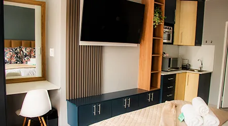 In-room amenities including kitchenette, workspace, and modern conveniences